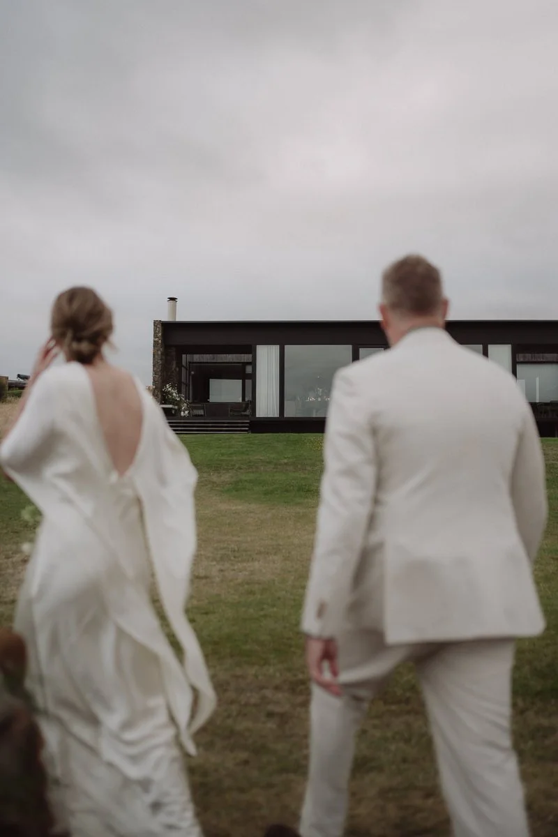 bride and groom walking back to their airbnb Seastone in Swansea Tasmania after eloping