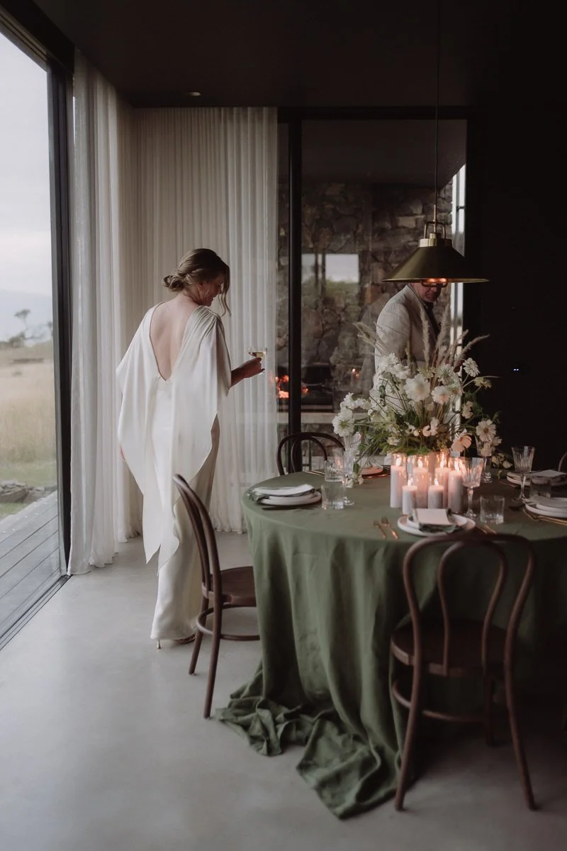 bride and groom walking next to their stylish dinner table at Seastone in Tasmania
