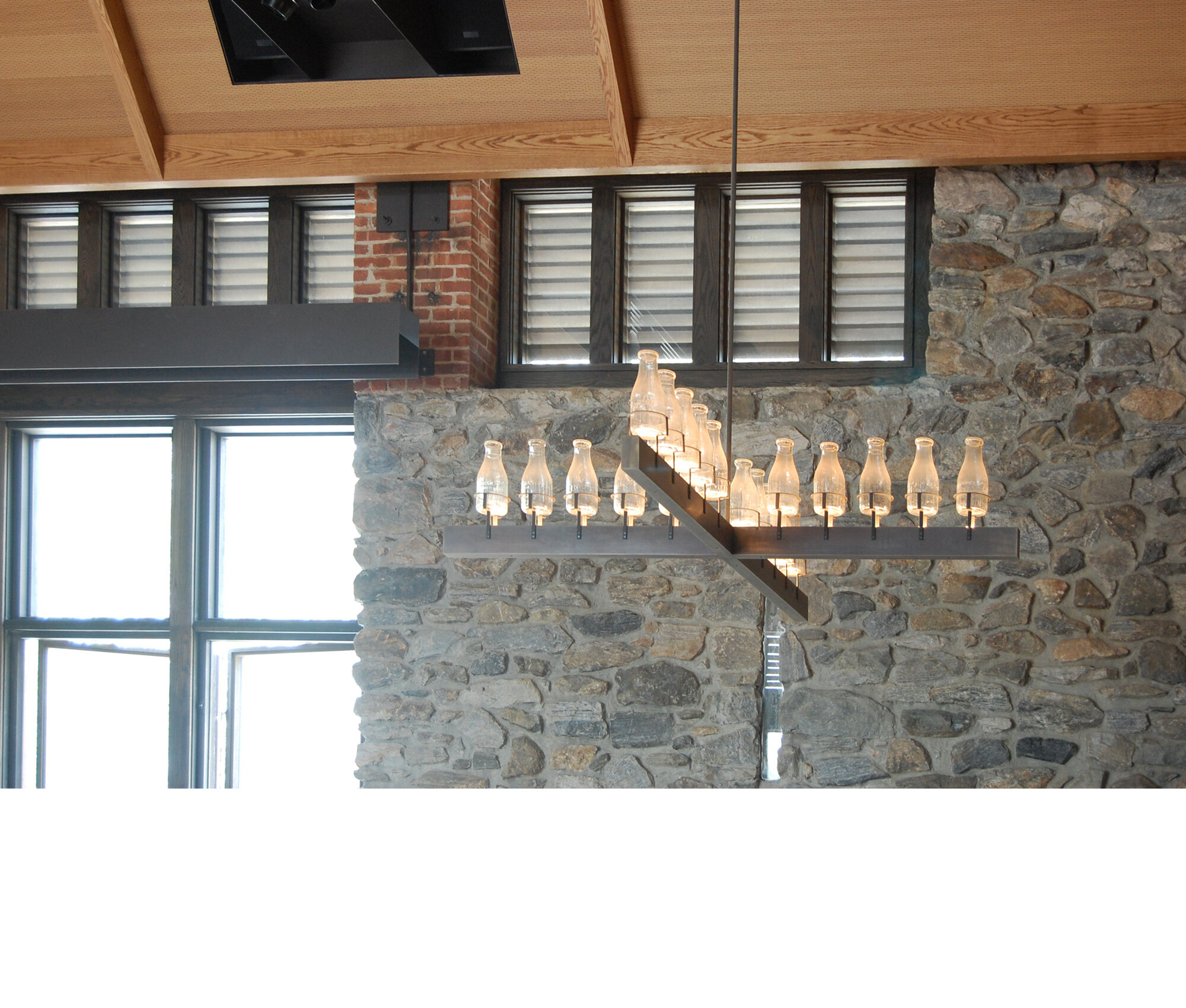 Prototype chandelier with local antique milk bottles.  Designed by Chris Lehrecke and Peter Guzy.