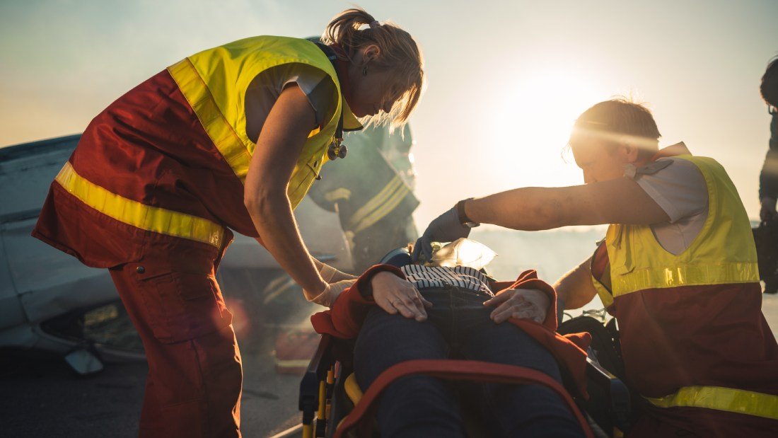 EMTs working on a person on a stretcher.