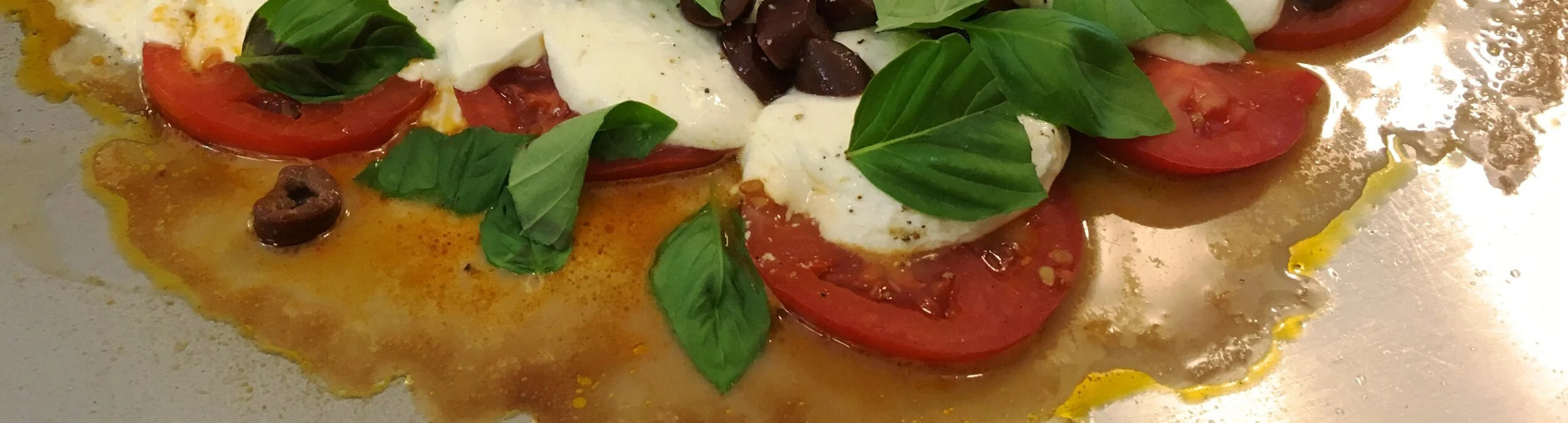Warm Tomato, Mozzarella, Olives and Fresh Fragrant Basil on the Teppanyaki