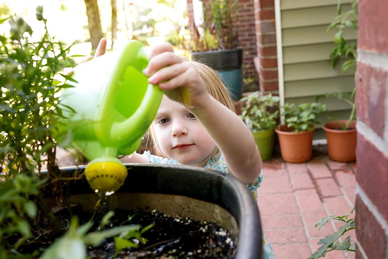 Watering the plants is serious business at this family photo session in Oxford, MS!