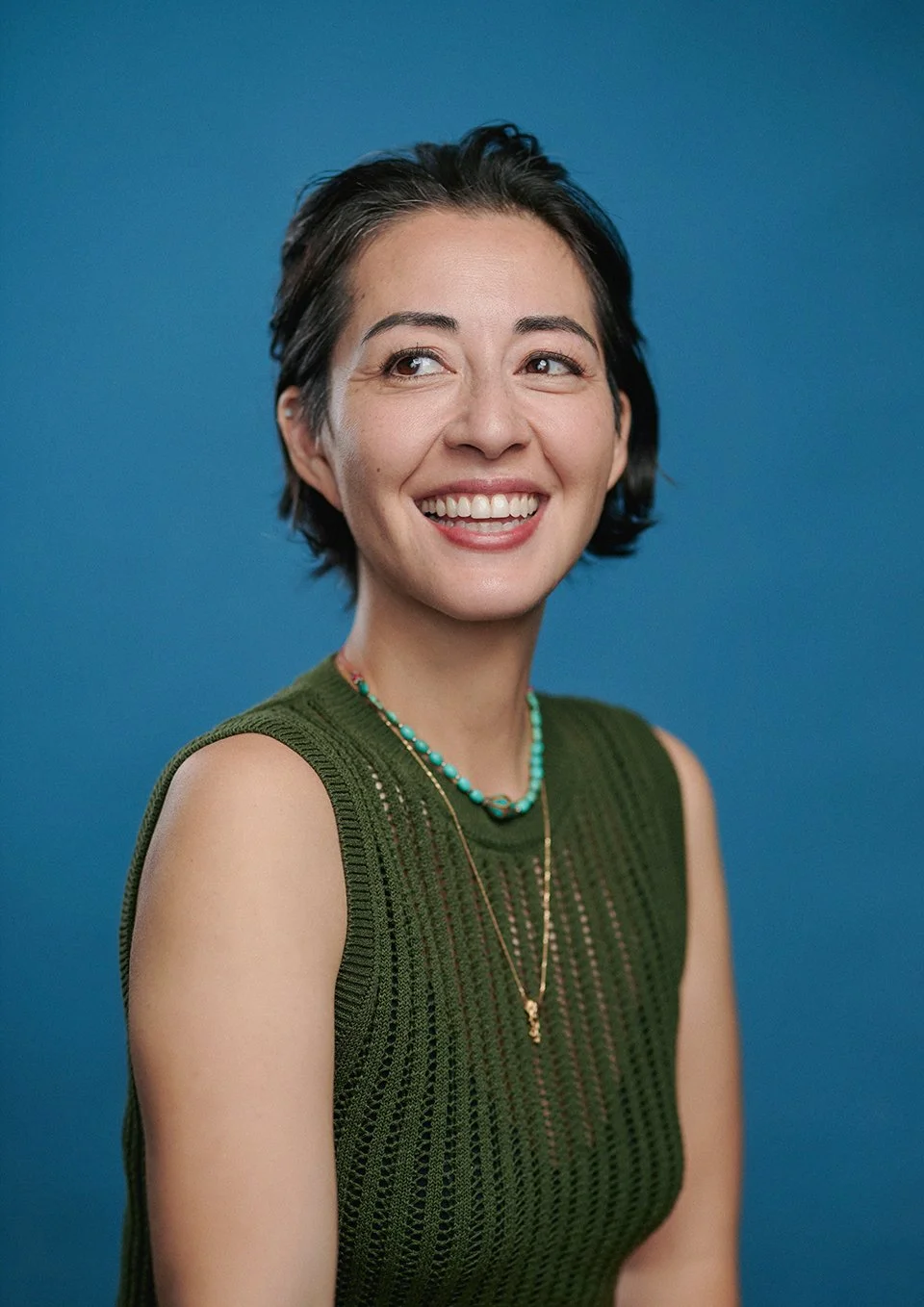 Jun Zee Myers Professional Portrait in London Studio with blue painted canvas background.jpg