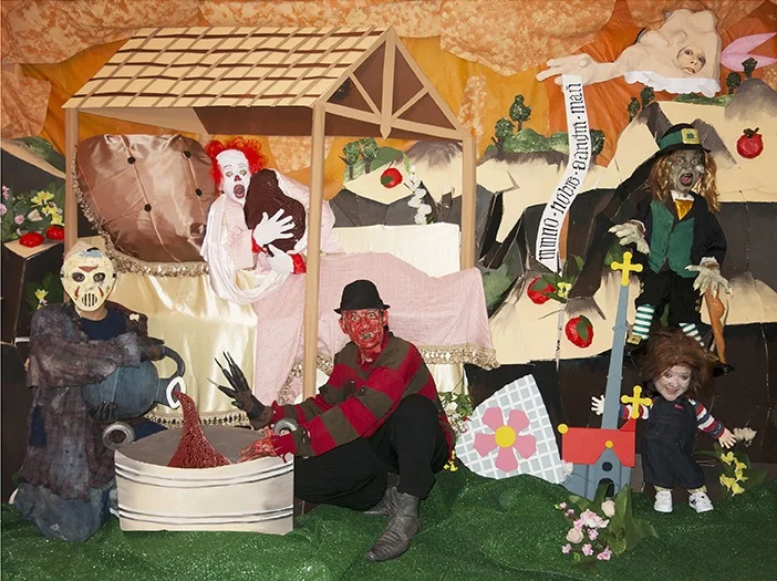 Self-portrait as Pennywise the Clown with the Blob, Jason, Freddy, Chucky, Leprechaun and Basketcase in re-creation of the Nativity scene from the Vyššì Brod Altarpiece (1350)