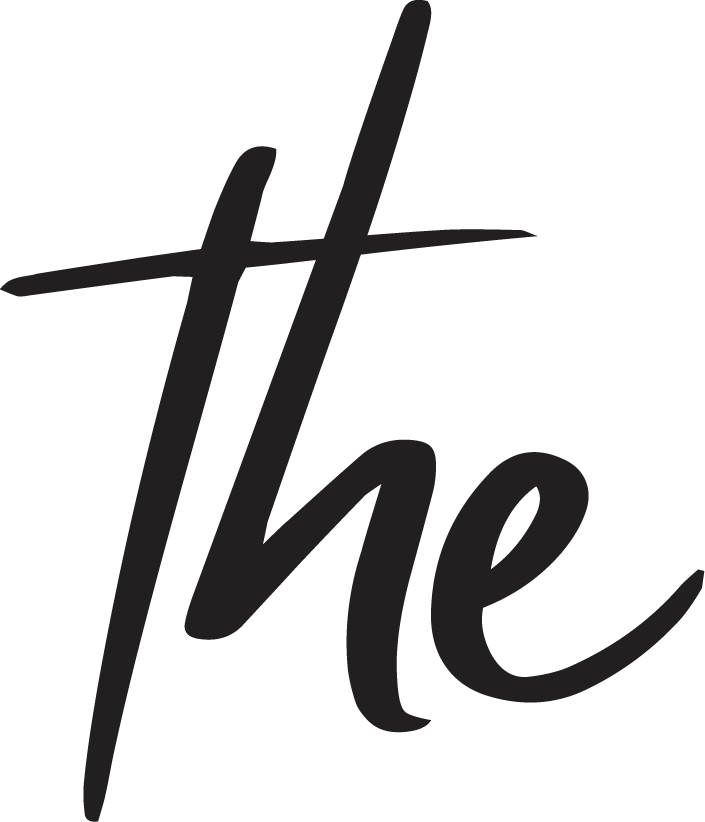 Close-up of a black fabric with the word 'the' written in cursive, black ink.