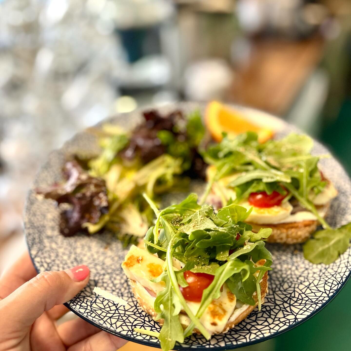 Today's beauty- Dukkah honey halloumi bagel with pesto, cream cheese, arugula, tomato and onion. Served with salad or chips!!