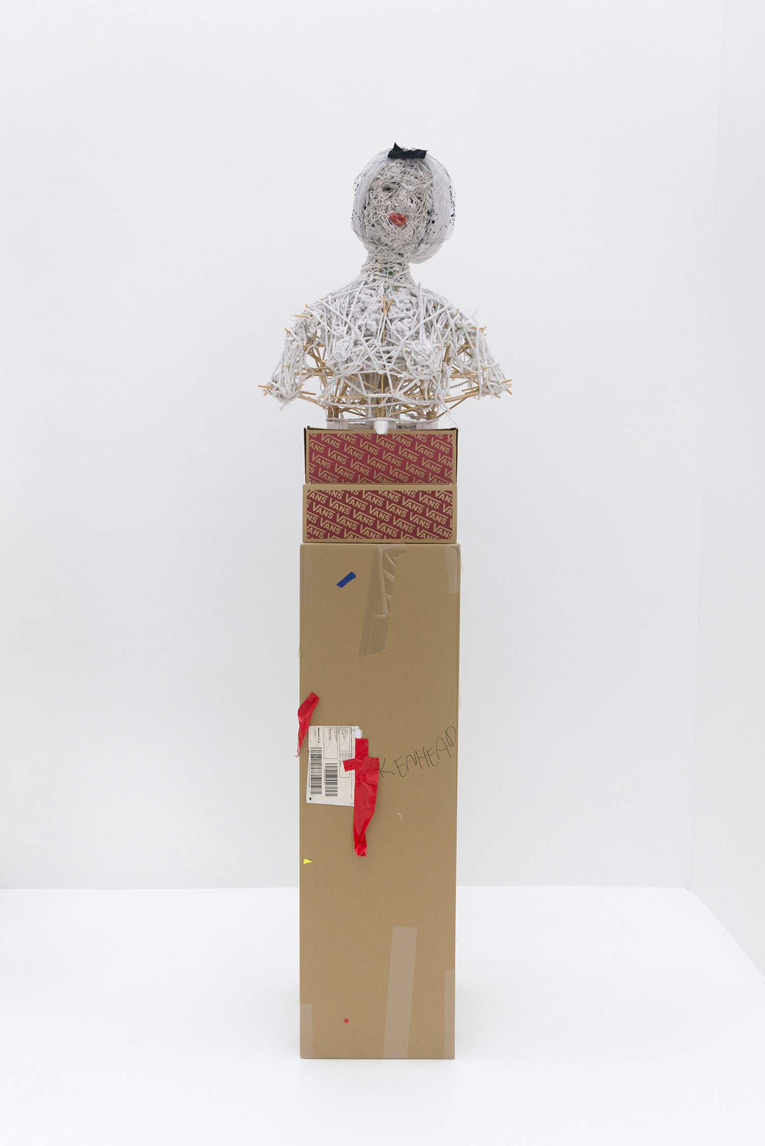   Monica , 2019. PVC, wood, cork, bamboo, plastic, cotton, wax, hat. Pedestal: cardboard, cotton twine. 