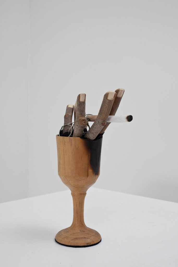 One thing leads to another , 2011, Wood, paint, lipstick, pantihose, modeling clay, found goblet, found puzzle ring.