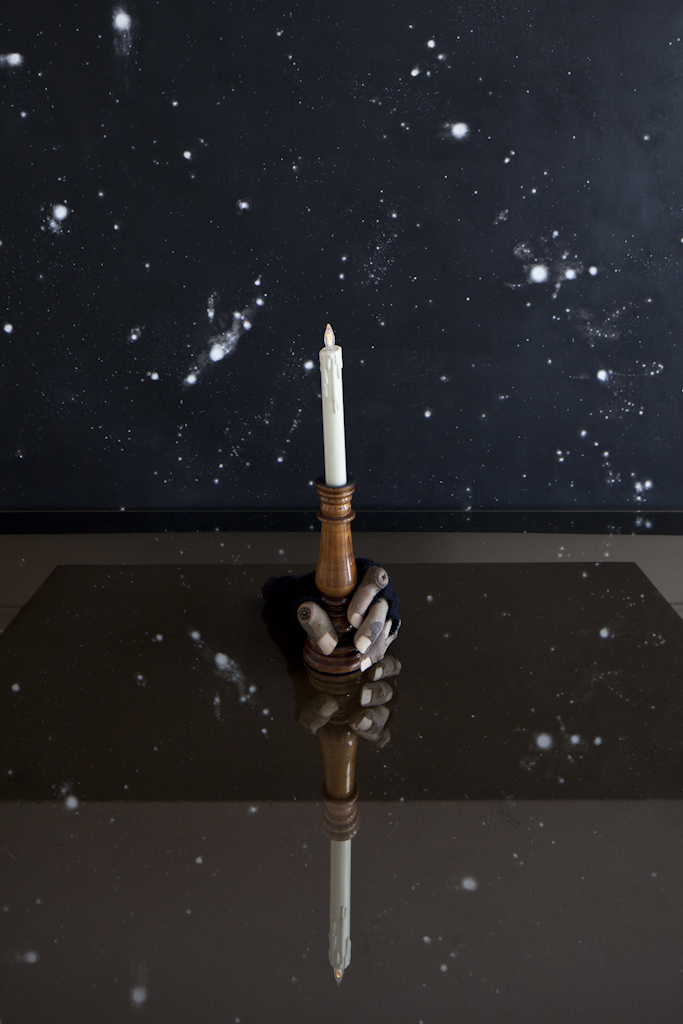 Signal , 2011, found candlestick, candle and glove, wood, wire, glue and felt on smoked glass coffee table; and Universe Visualisation Prop, 2011, acrylic on unstretched canvas, metal eyelets.