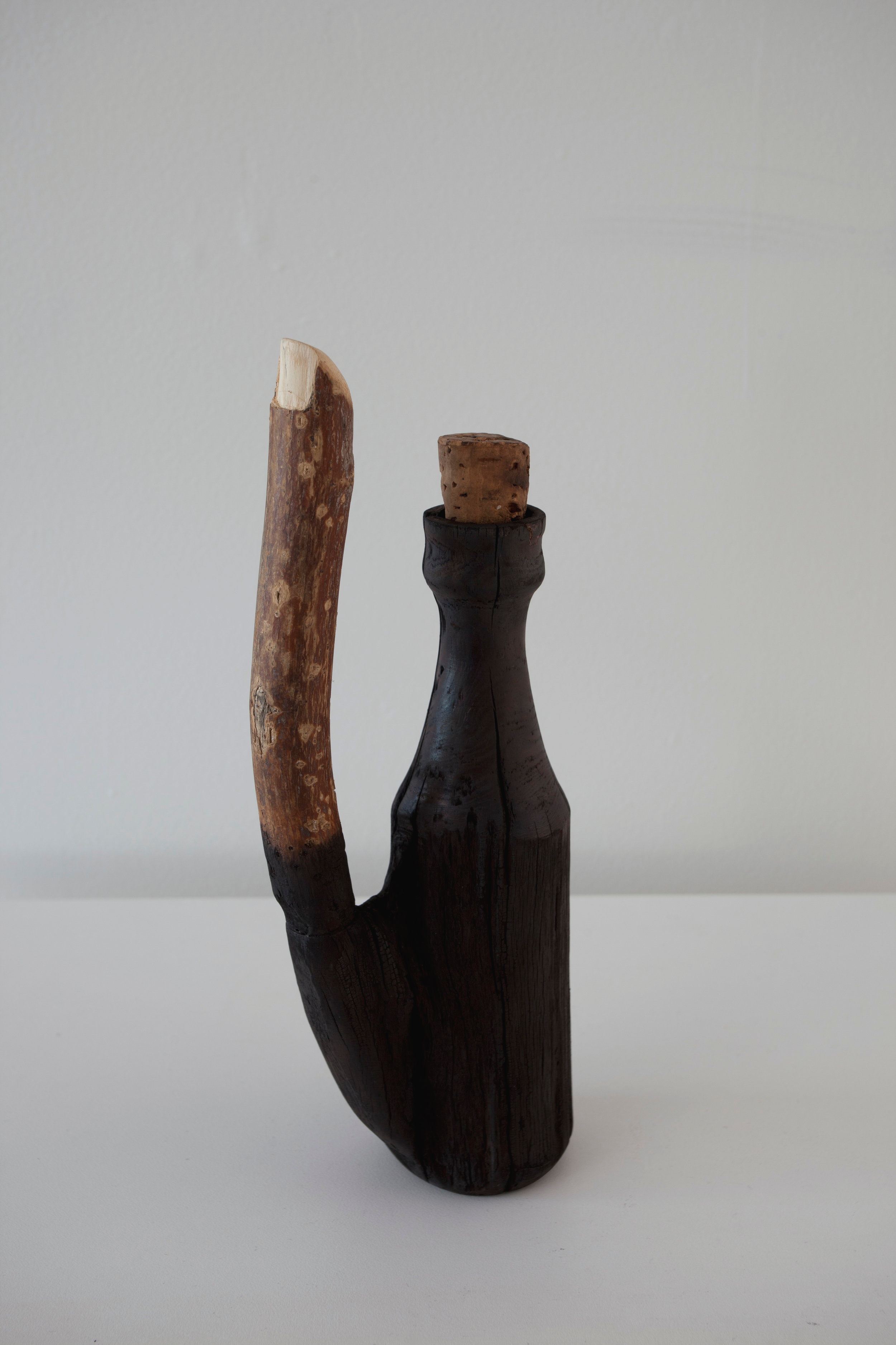 Bottle , 2011, wood, cork, nail, charcoal, found bottle.