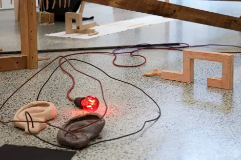  Installation view of  Ego. 2024.  Fired clay and  Vagus. 2025.  Fired clay, wire, bleach on calico and  Lamp.  2025. Steel conduit, electrical cable and components. 