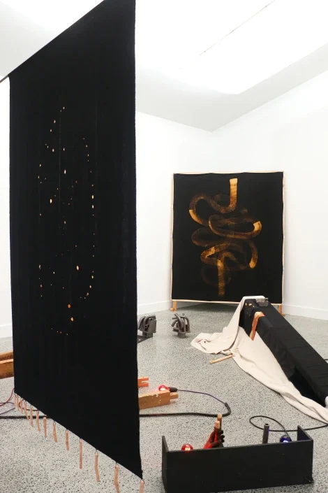  Installation view including  Guts . 2025. Calico, bleach, belting, pine bed frame, tacks and  Cosmos . 2025. Calico, fired clay, cord, steel bar and&nbsp; Treatment.  2025. Anagma fired clay, bisqued clay, canvas drop-cloth, silk, calico, velvet, th