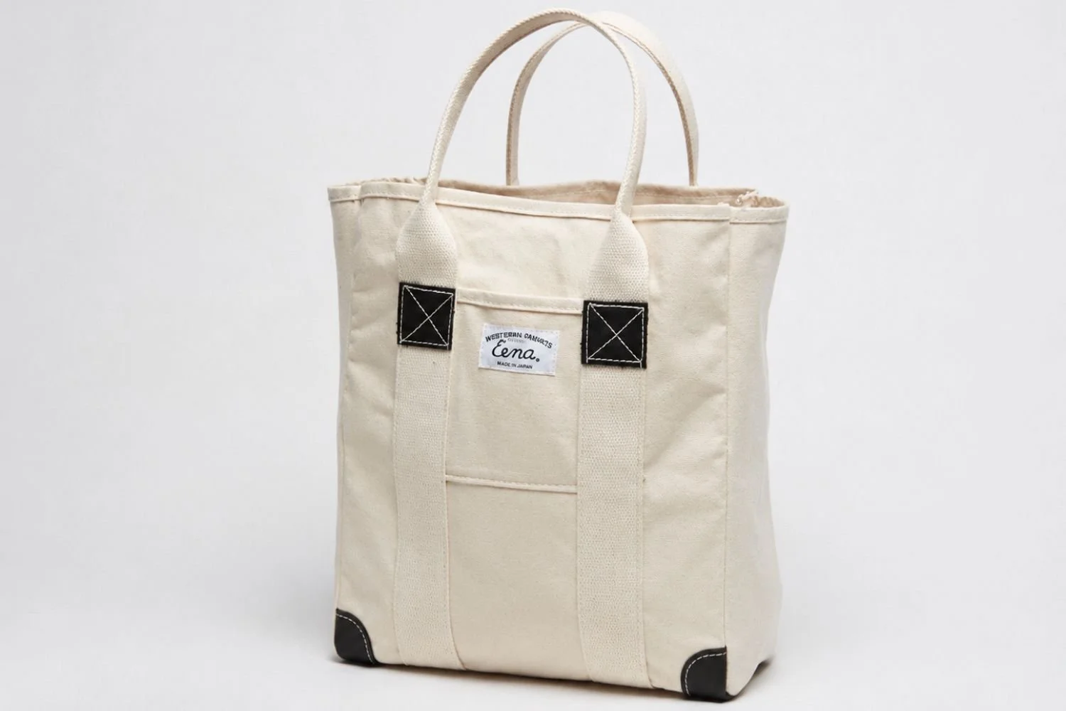 natural canvas tote with white handles on white background