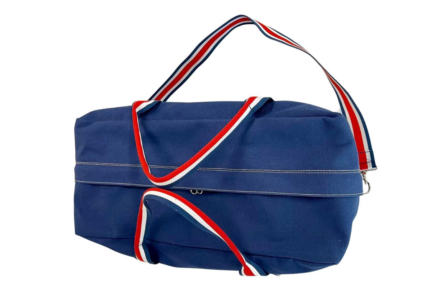 top of red white blue duffel bag on white background