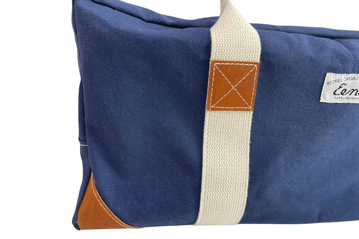 navy canvas duffel with brown leather details