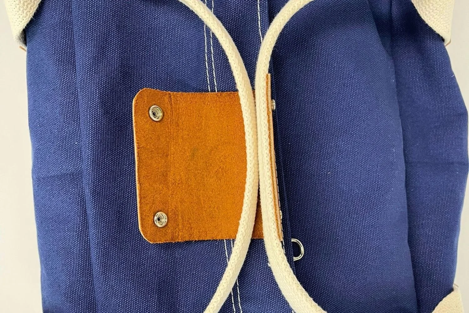 webbing and leather handle on duffle