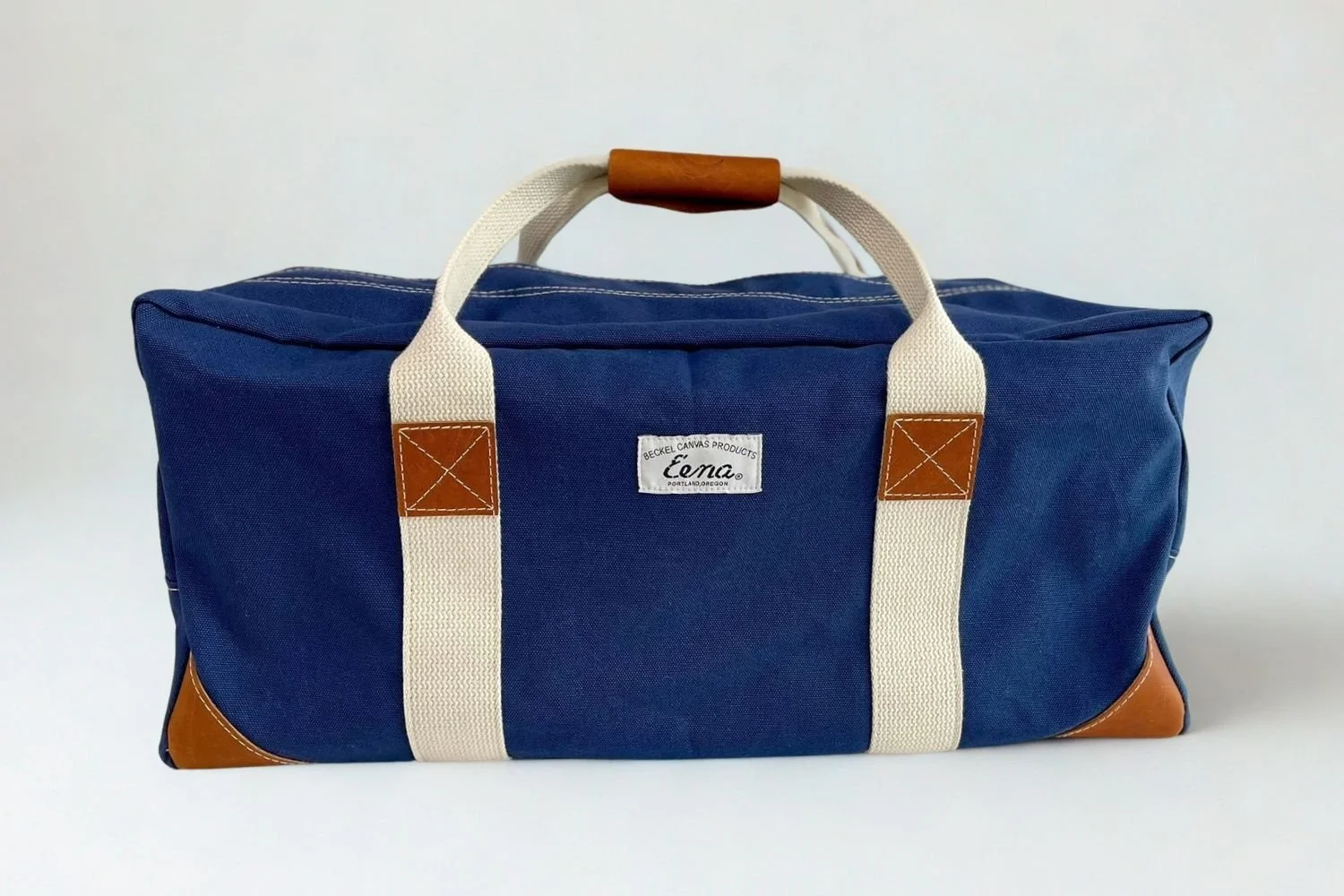 navy and brown duffel bag