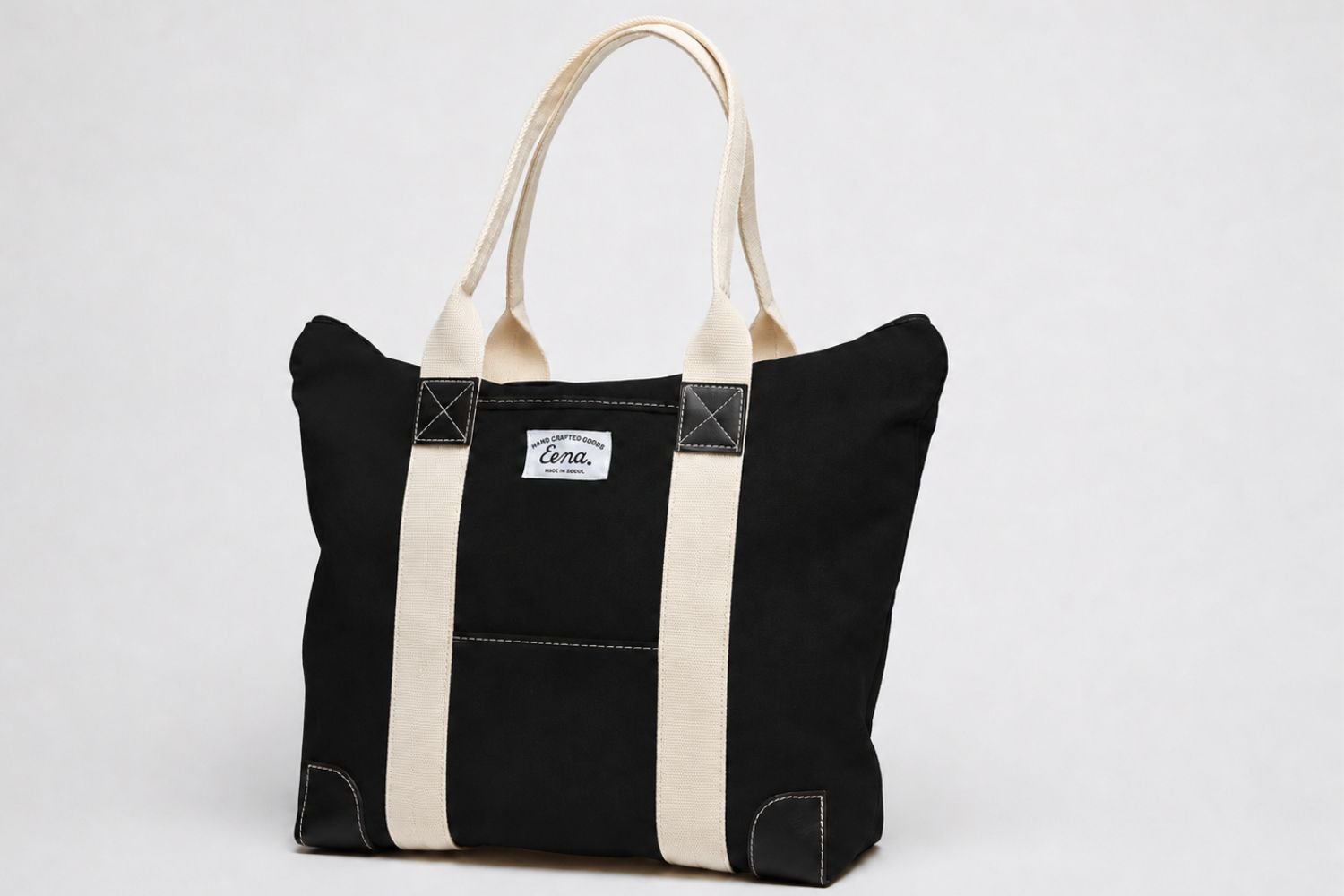 black canvas zip tote on white background