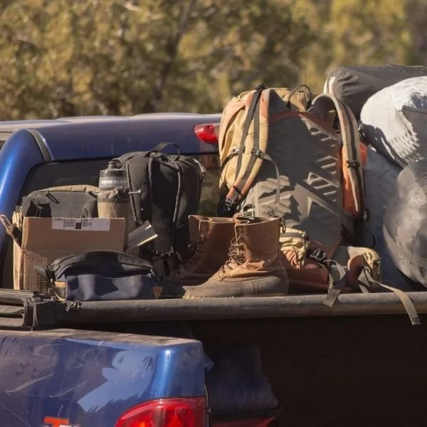 truck bed filled with camping gear, emergency supplies and go-bags