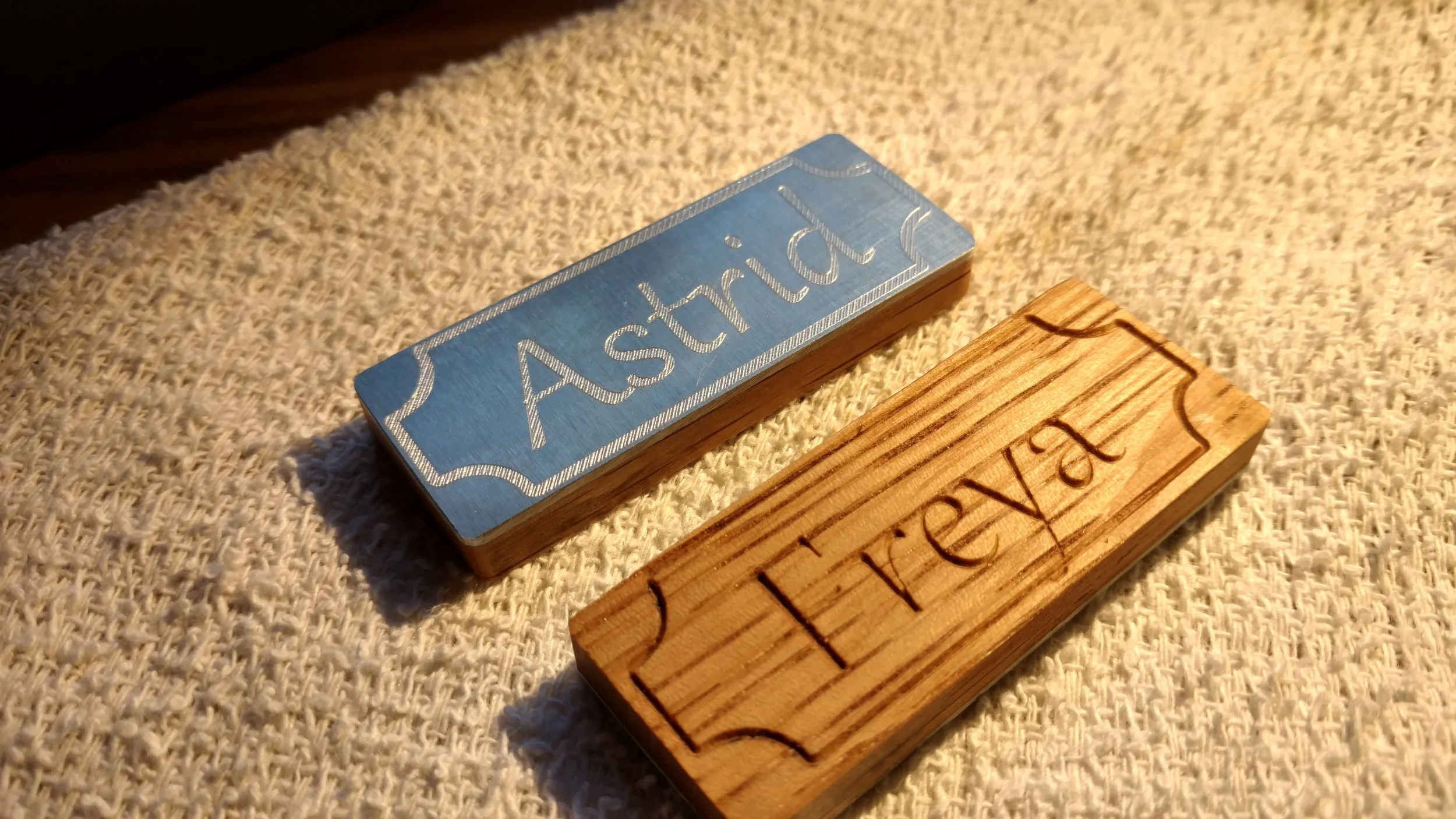 Both are two sided, aluminum and white oak.