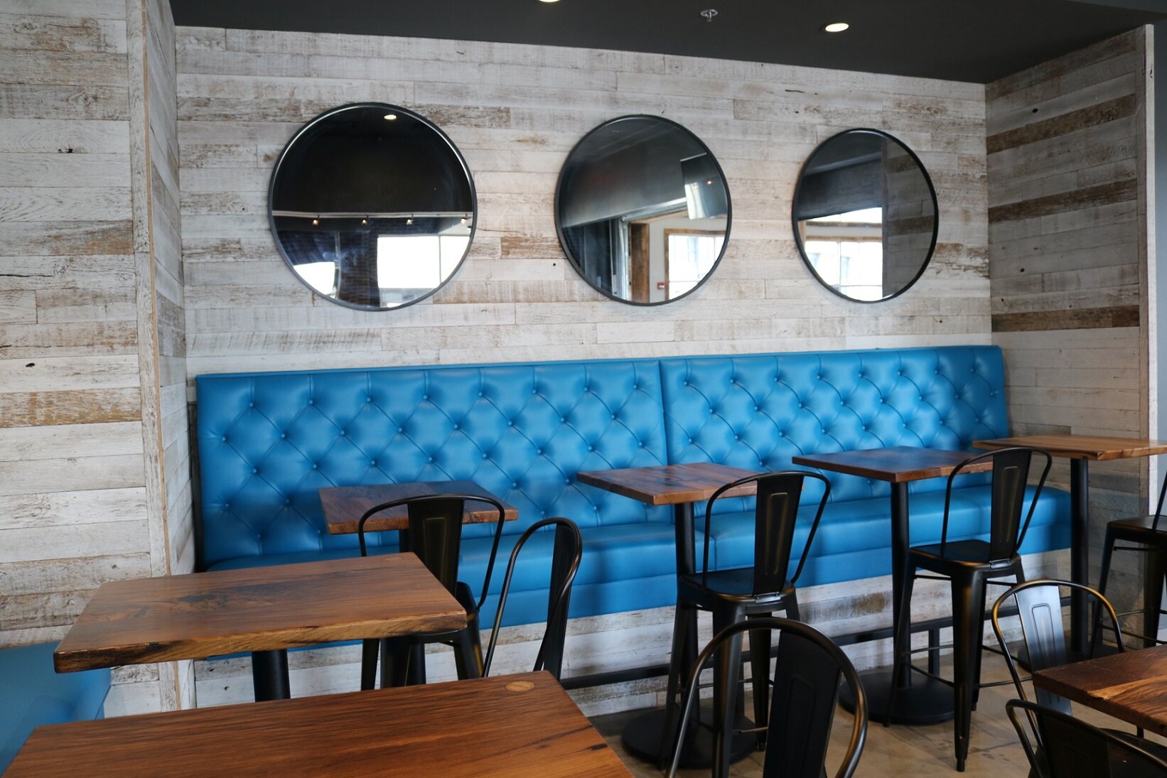 White washed reclaimed wood paneling in use in a cafe