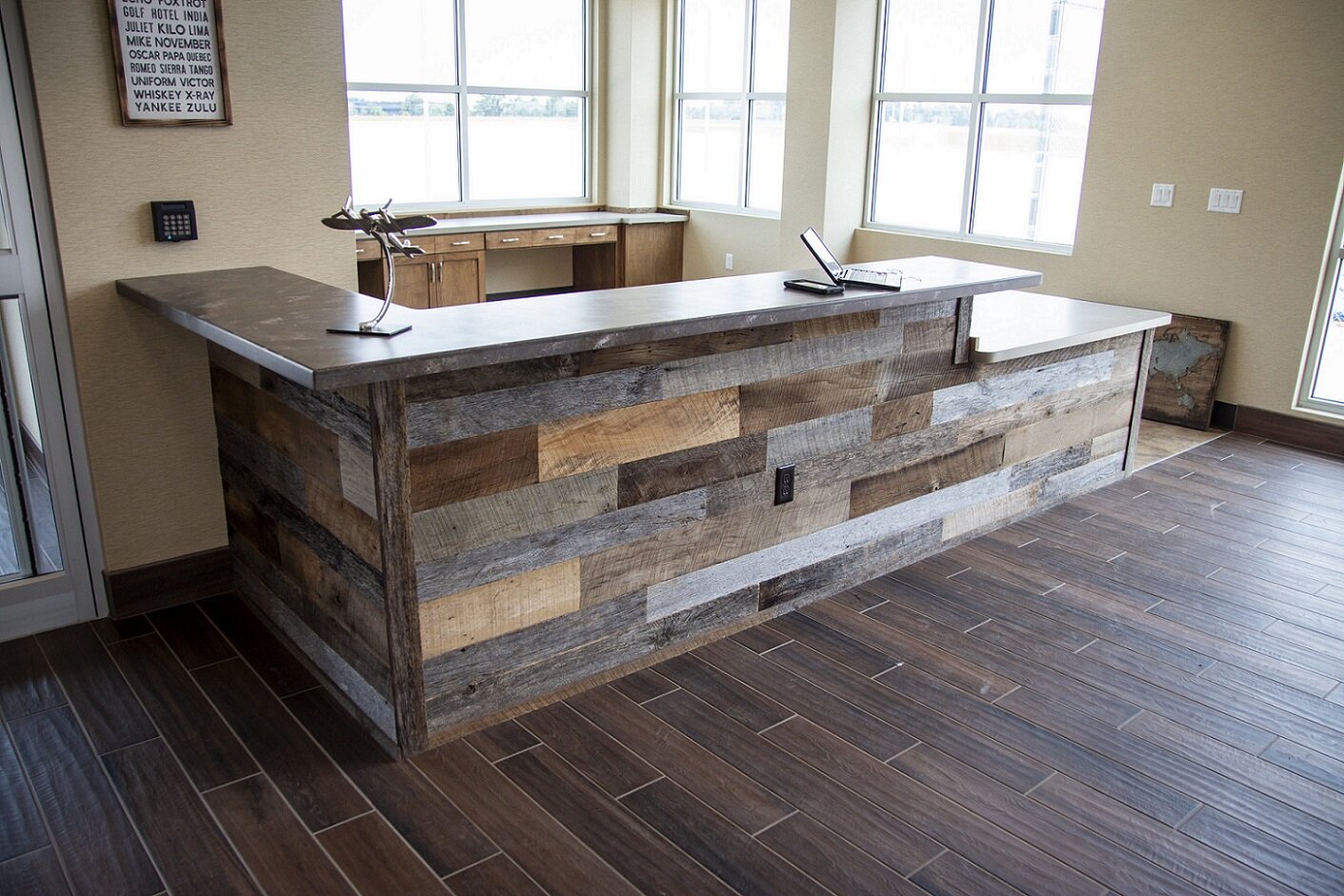 reclaimed hardwood paneling in use as cabinet cladding at an office