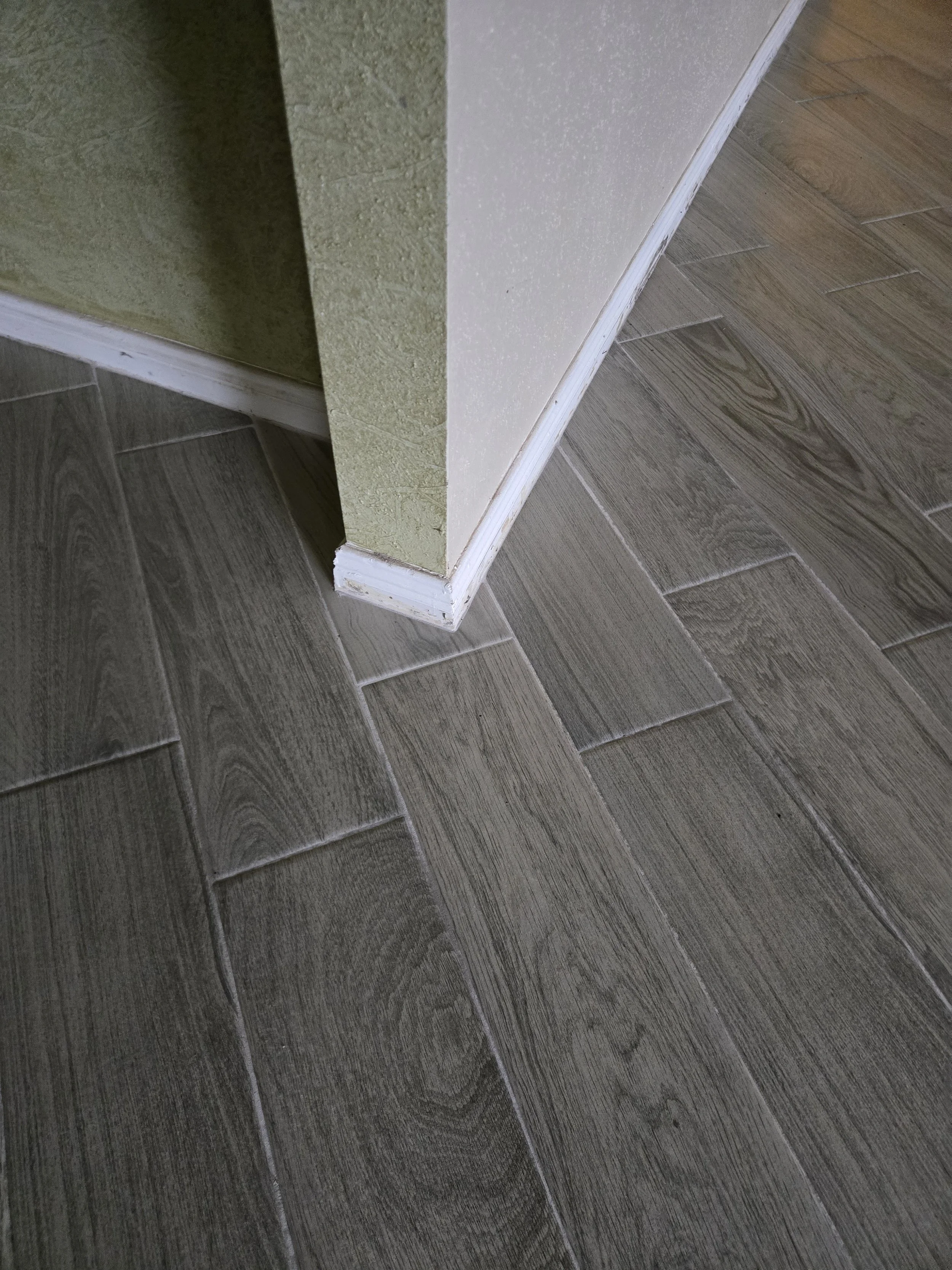 This is an image of some cracked paint on the baseboard trim that needs painting