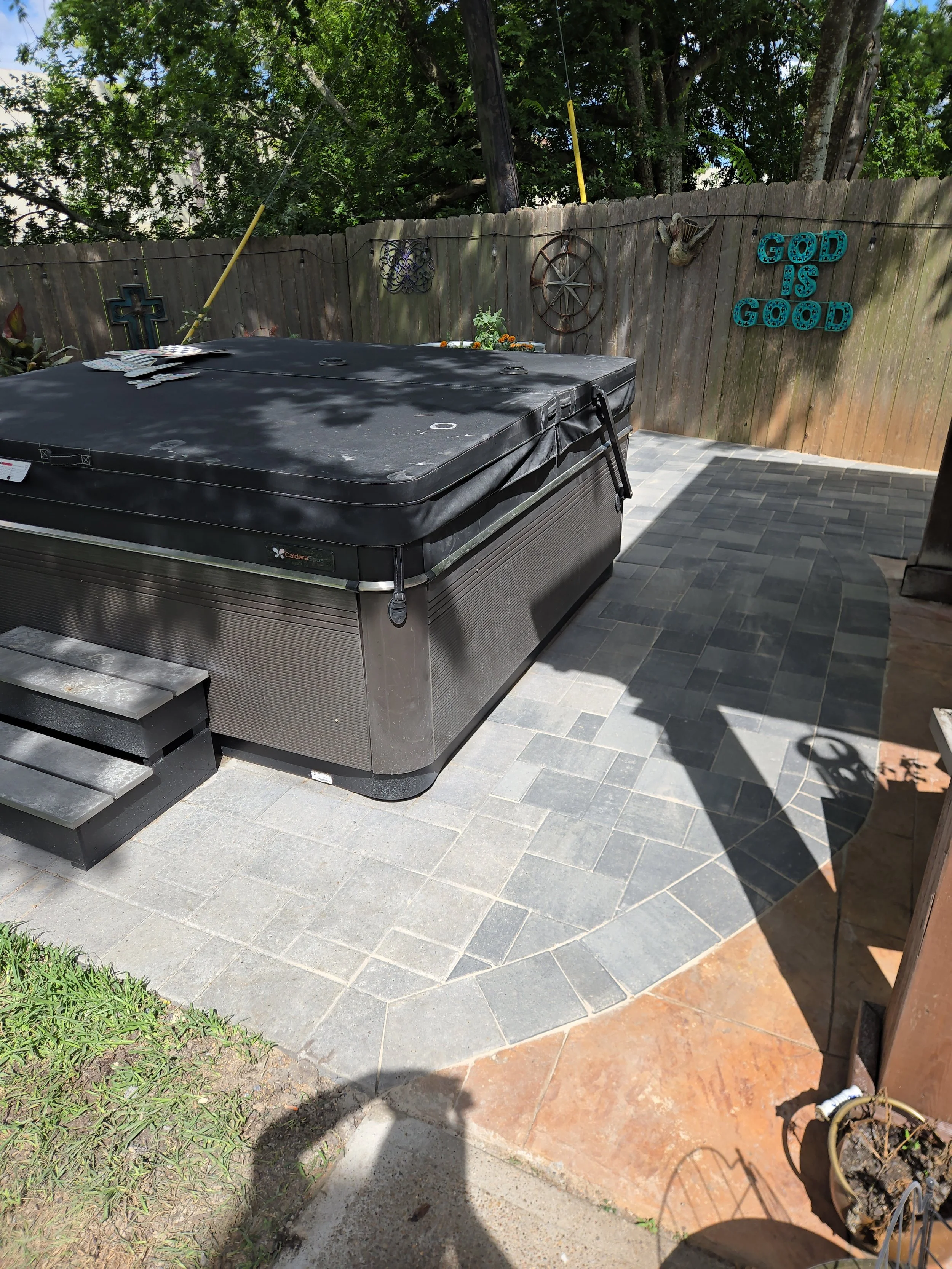 This is an image of a hot tub on top of pavers in a yard in southeast houston