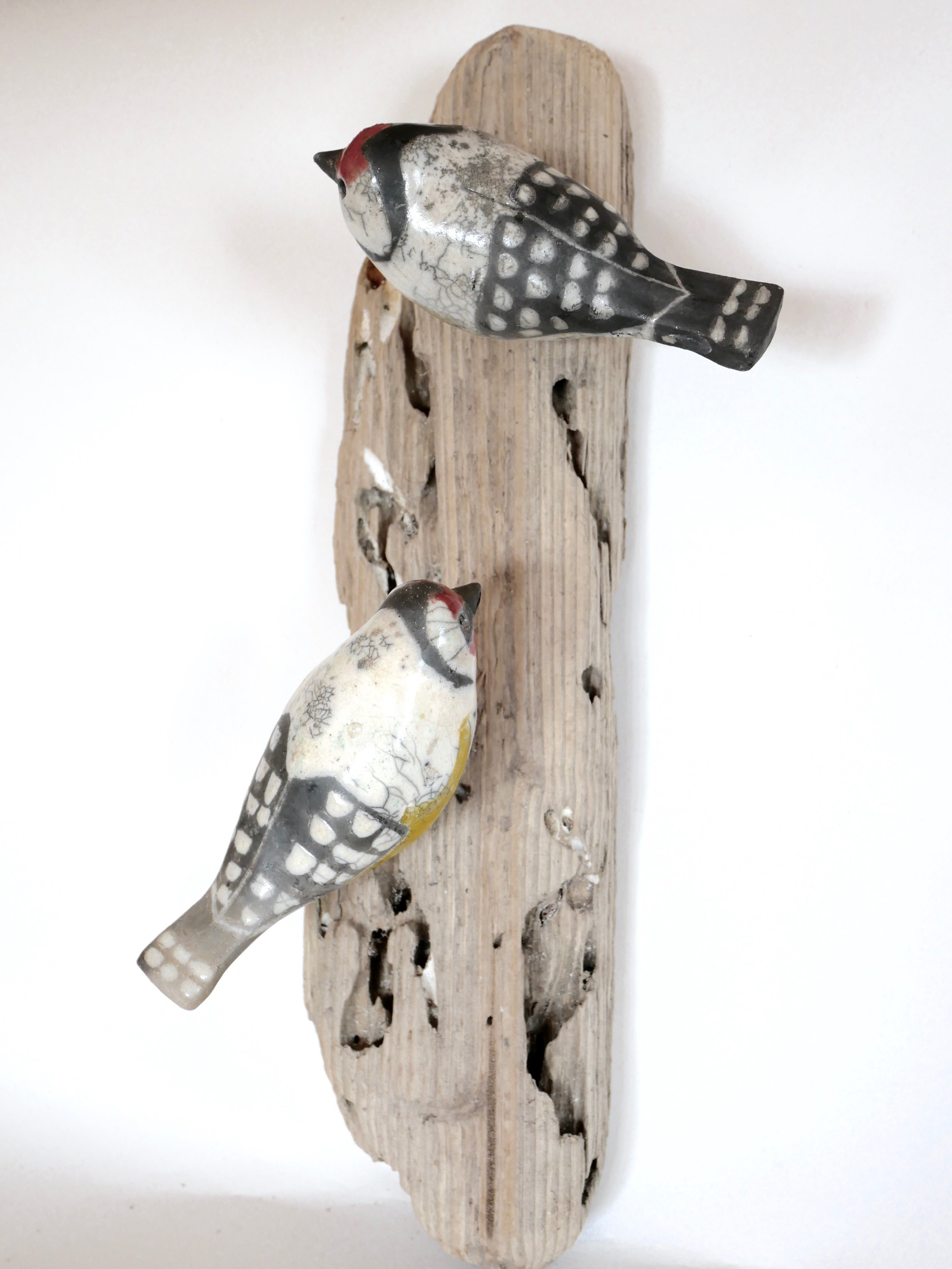 Raku Goldfinches on driftwood