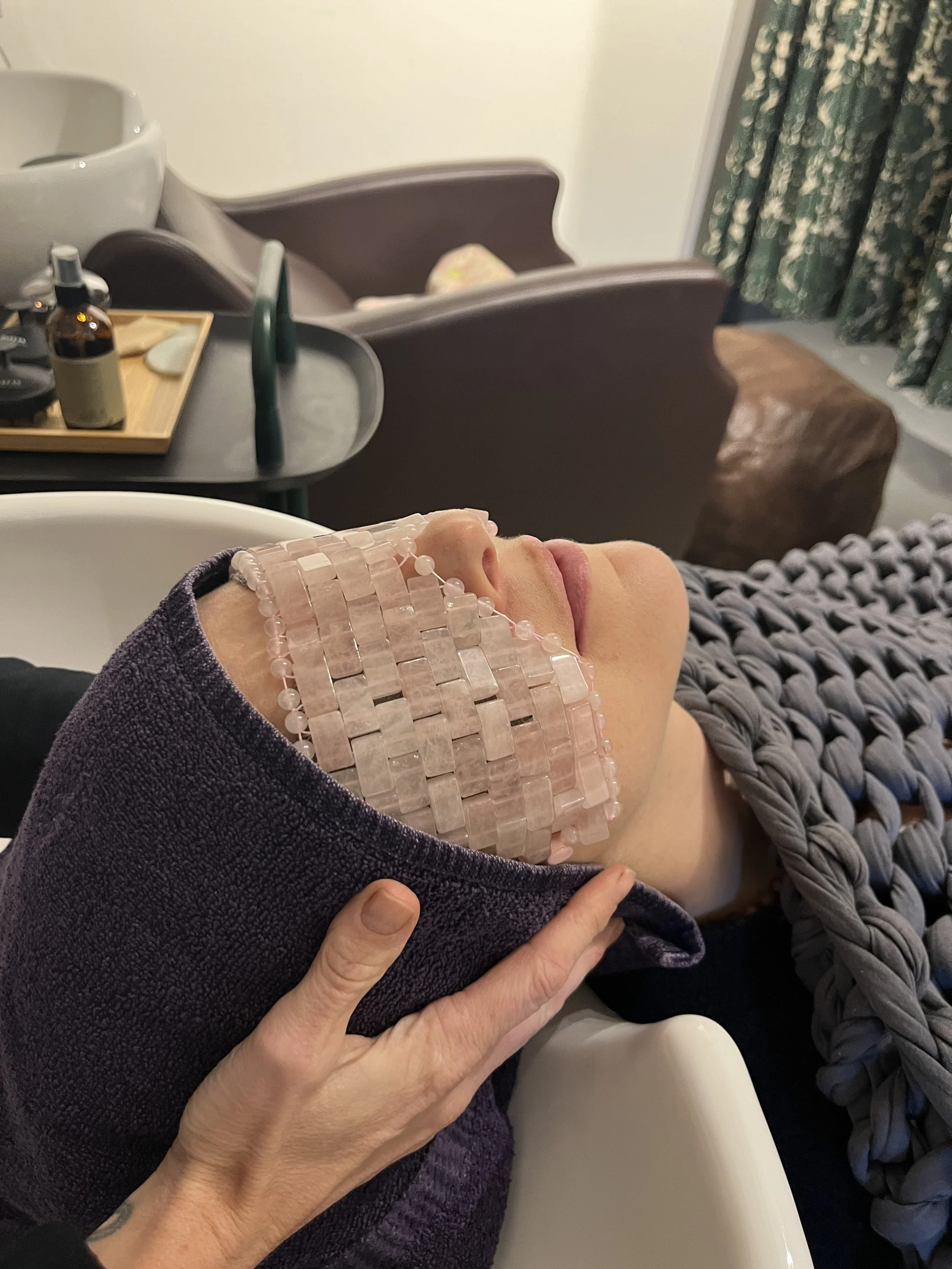 Woman relaxing with rose quartz eye mask