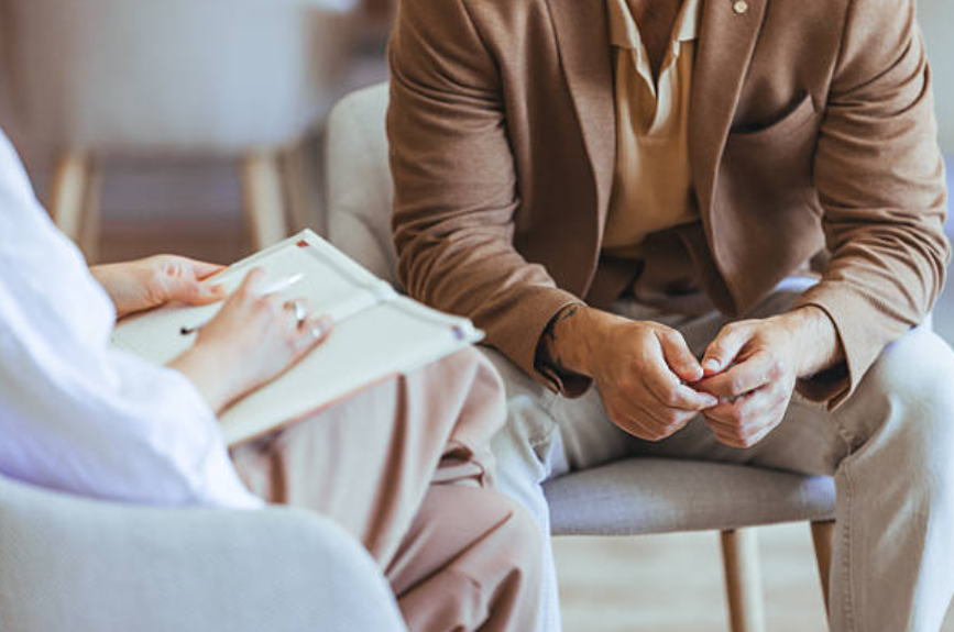 Therapist providing supportive counseling during an in person therapy session.