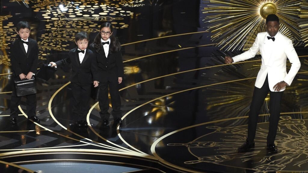 Chris rock’s comedic skit featuring three of his Asian “accountants” at the 2016 Academy Awards. Photo: BBC News
