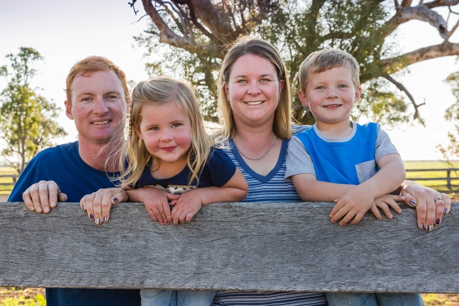 Farm Family smiling from rail post.jpg