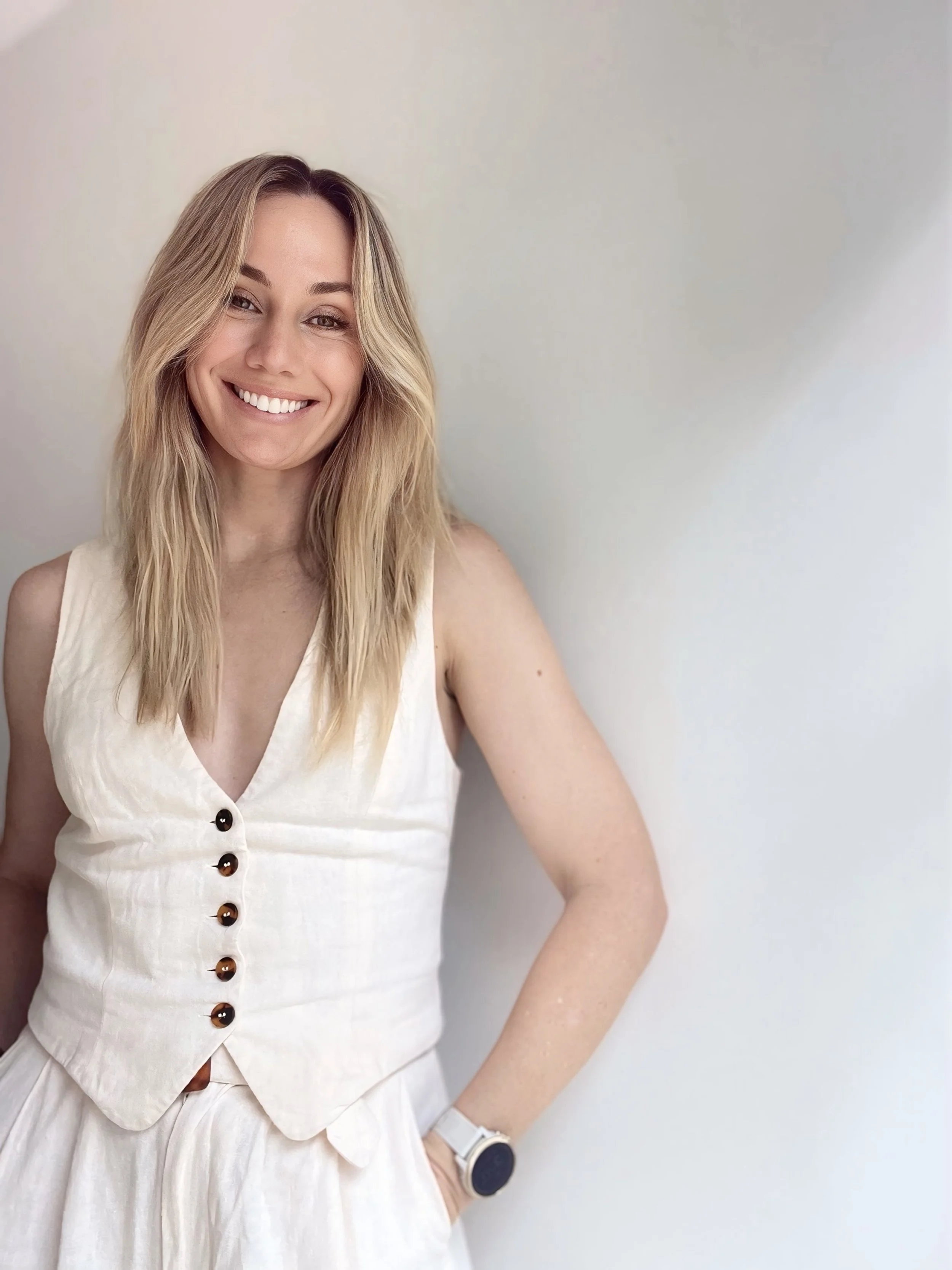 Picture of Georgi, smiling and leaning up against a wall.