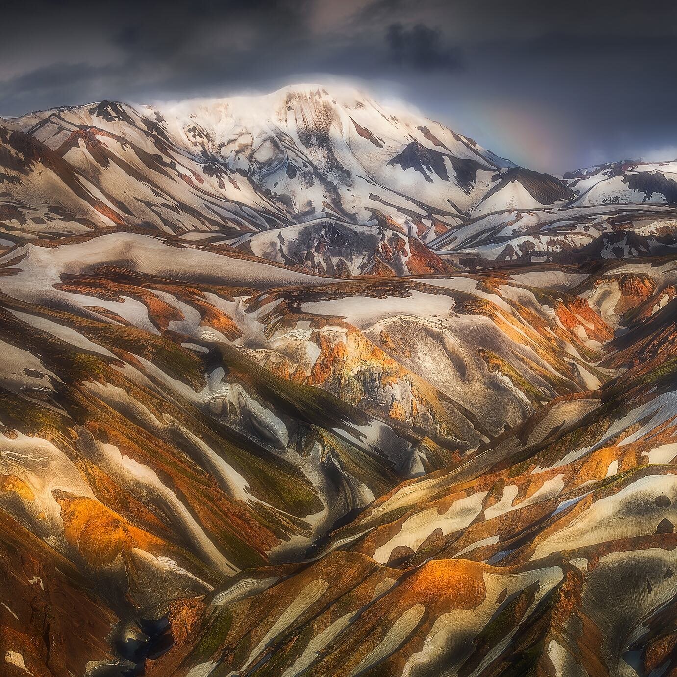 &laquo;&nbsp;Enigmatic Glow on Rhyolite Mountains&nbsp;&raquo;

In the shadow of light .. The last rays of midnight sun on my back caress the Rhyolite mountain range of Landmannalaugar for an ephemeral instant. Only 5 minutes later I was engulfed by 