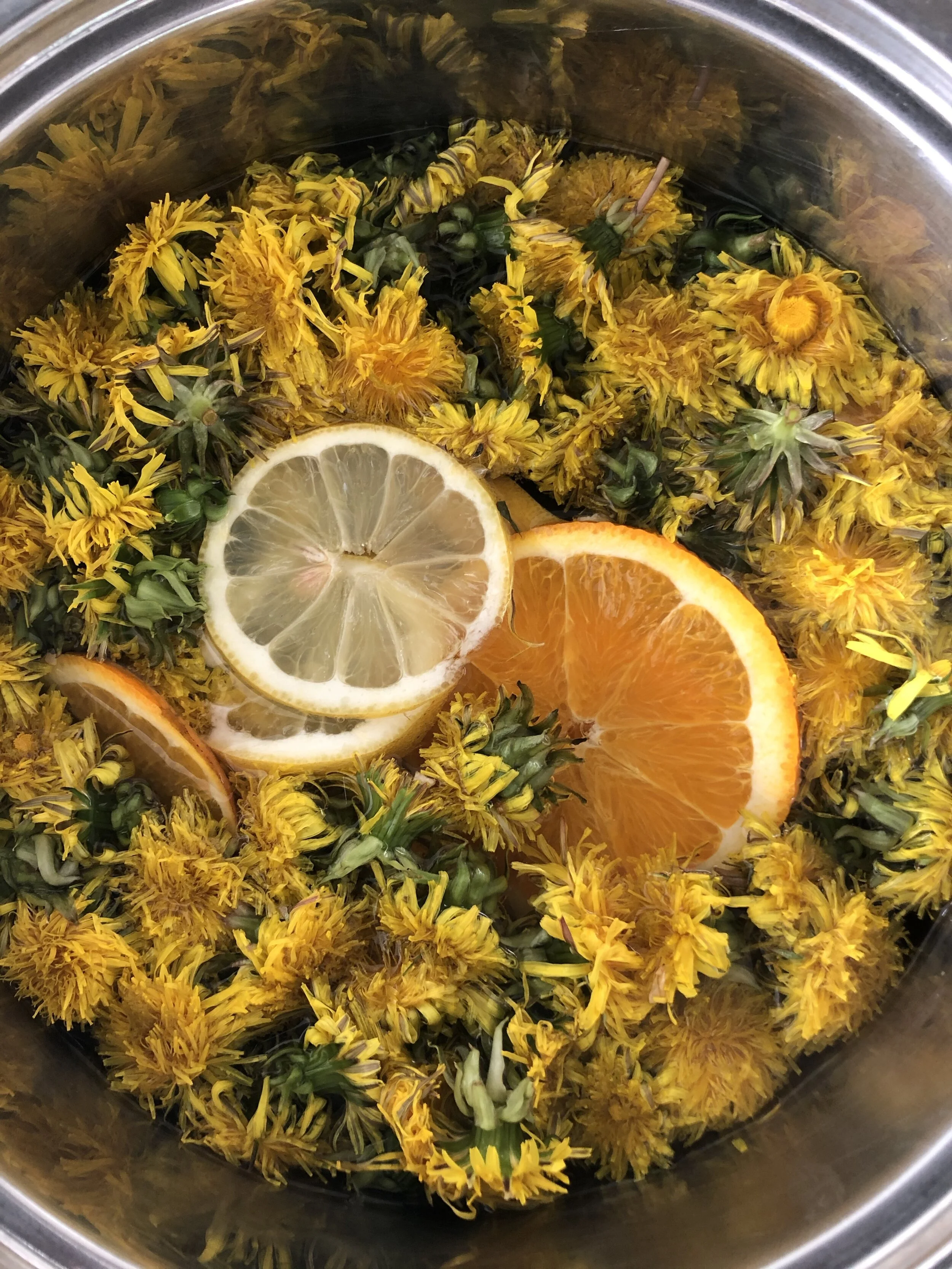Dandelions, citrus and water in a bowl