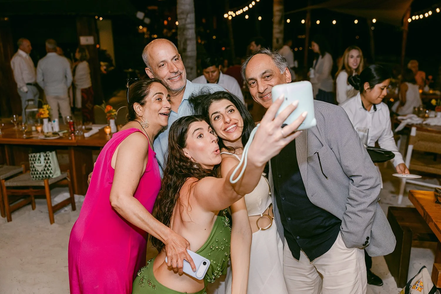 21 bride taking photos with her family in the welcome party.JPG