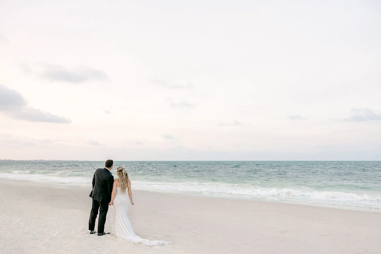 50 beautiful beach landscape and bride and groom looking to the horizon.JPG