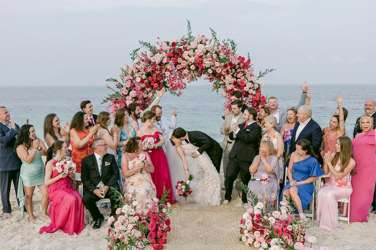 42 wedding guests celebrating bride and groom's kiss weddin by the beach in cancun riviera maya mexico.JPG