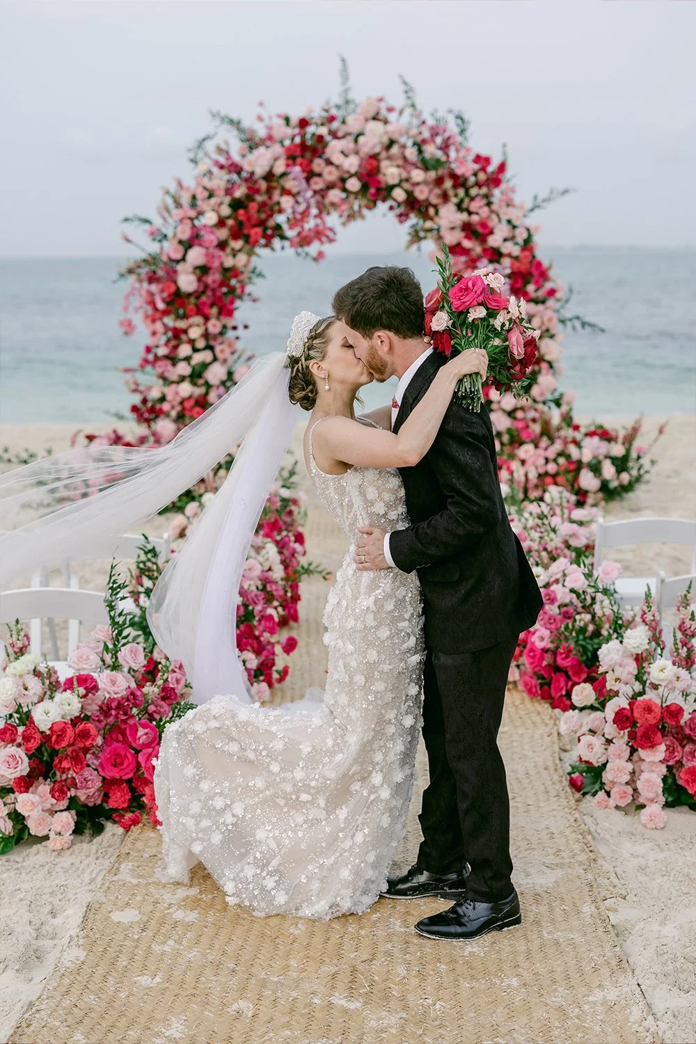 44 bride and groom kissing walking down the isle by the beach.JPG