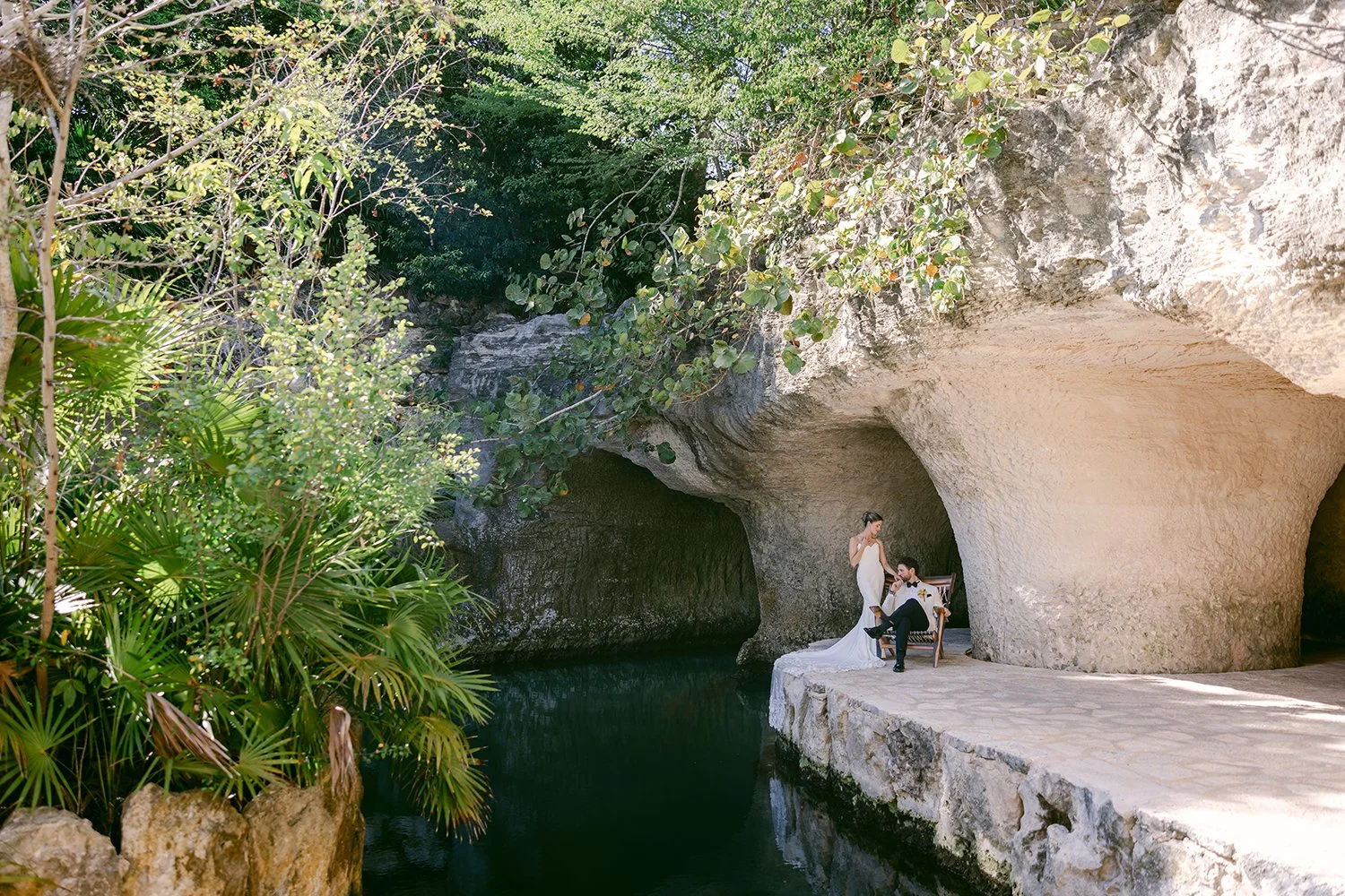 19 bride and groom sitted posing with a tropical view in a cenote in cancun hotel xcaret.JPG