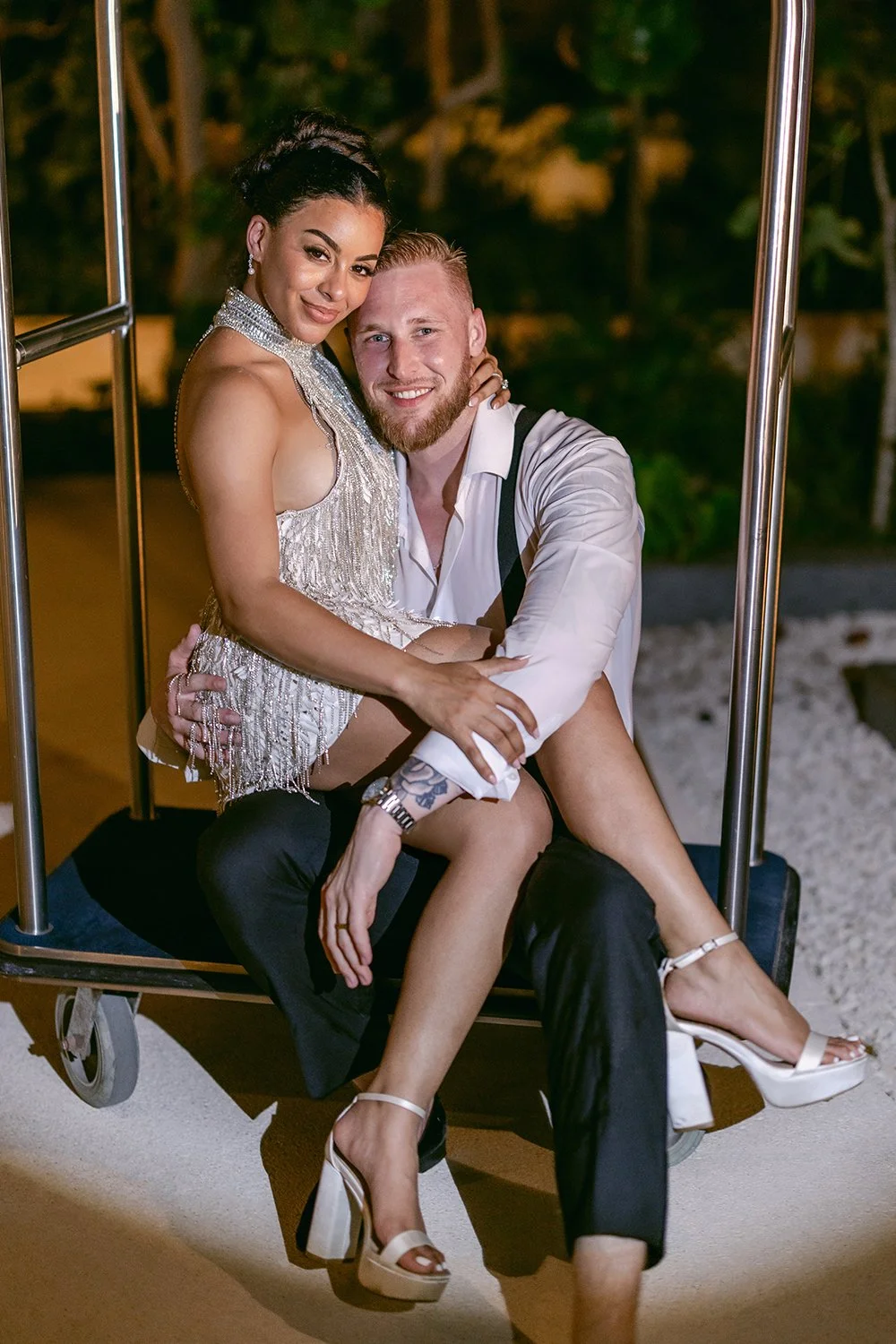 68 bride and groom beautiful photo sitting on a bell cart and posing looking at the camera.JPG