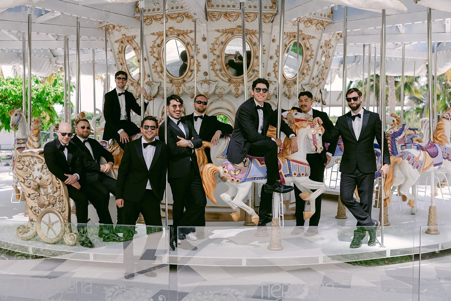 21 groom with his groomsmen posing in front of a beautiful carousel.JPG