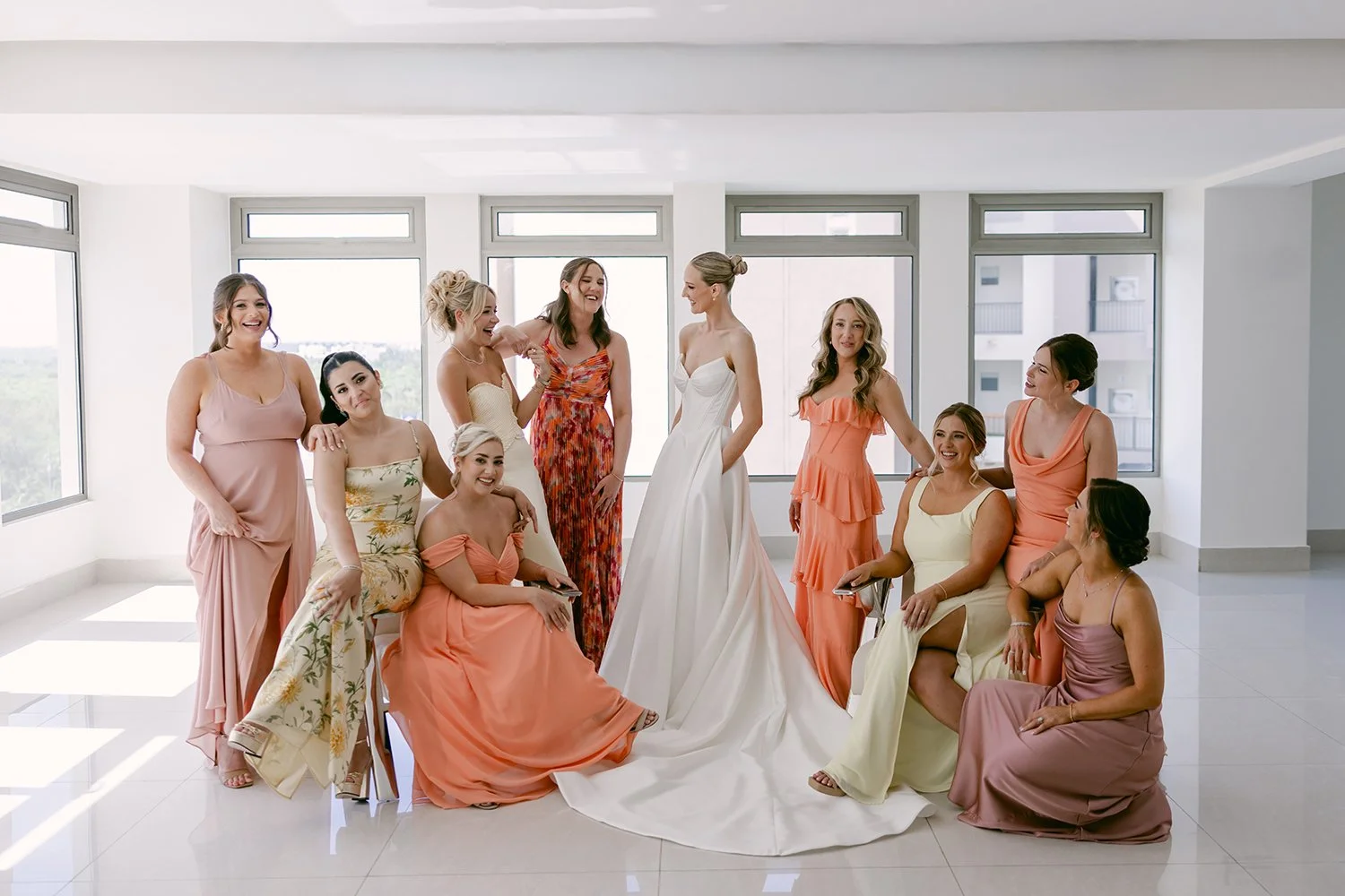 22 bride posing with the bridesmaids before the first look with the groom all wearing beautiful colorful dresses.JPG