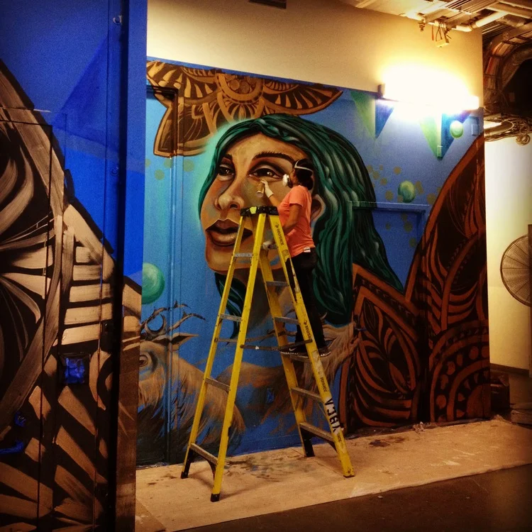 image: Erin Yoshi paints the first mural series at Yerba Buena Center for the Arts.