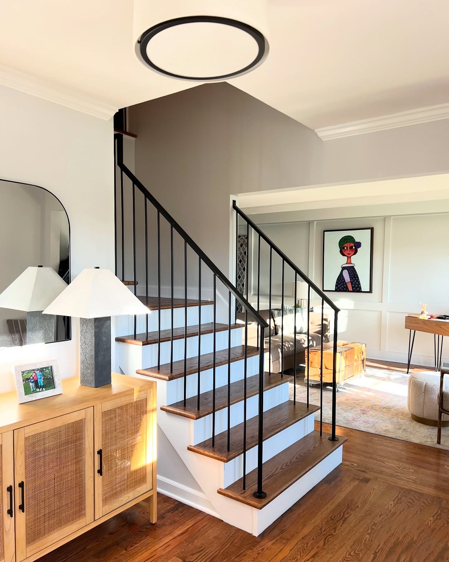 A redesigned staircase that is not only beautiful but makes the space feels larger and more open, allowing for more natural light to bounce around the room. A fun project! 

Staircase railing: Artistic Iron Works 
Flooring: Five G&rsquo;s Constructio