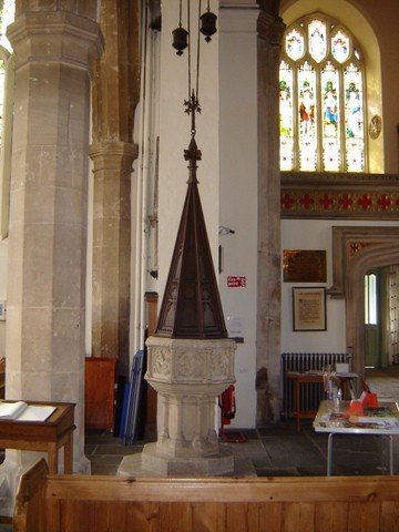 The baptismal font beside the tower