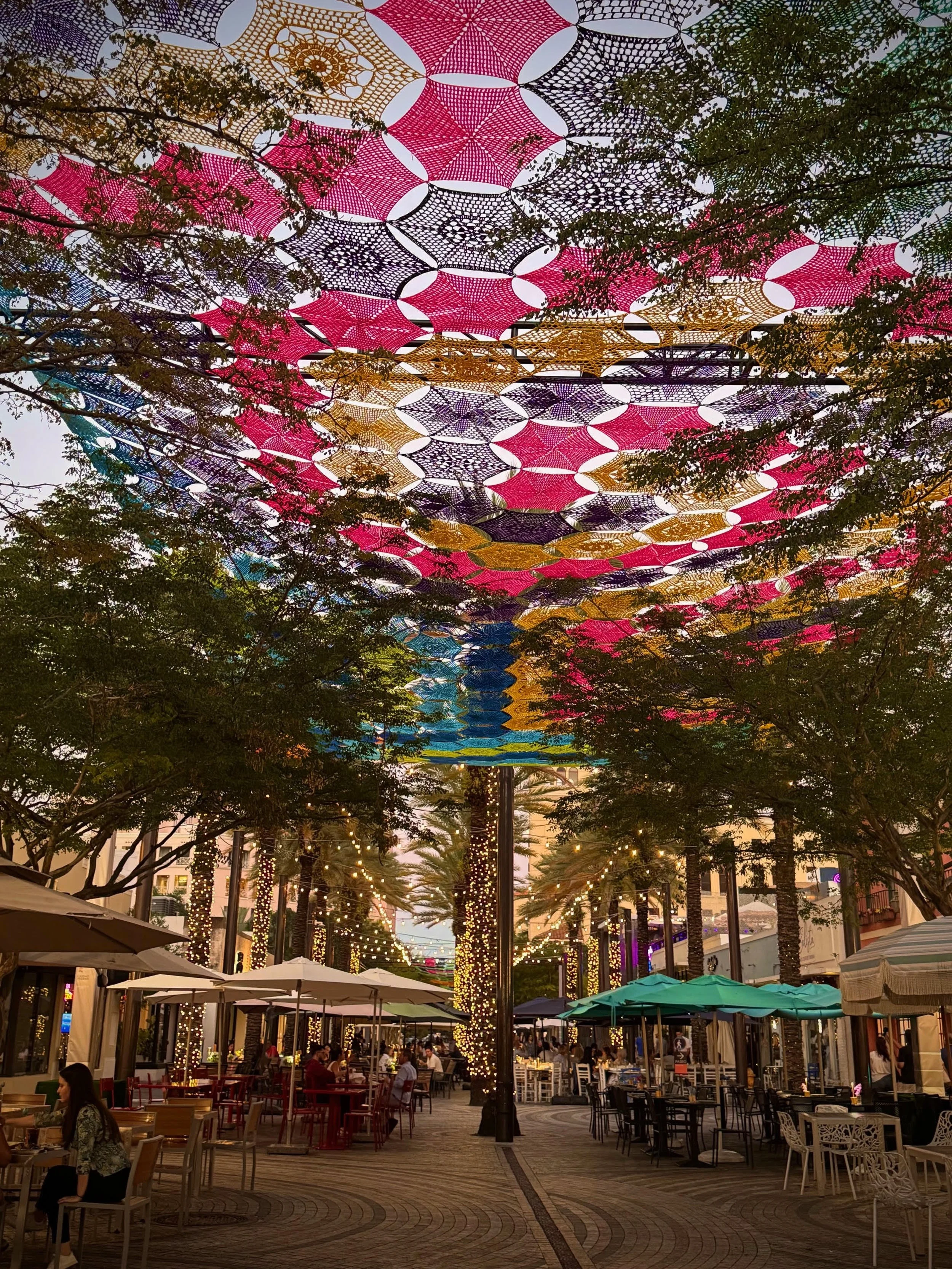 The 2026 Giralda Plaza art installation in Coral Gables features a vibrant, handwoven canopy created by artisans from Etzatl&aacute;n, Mexico. Displayed from May 1 to July 31, 2026, this free, immersive, and award-winning crochet exhibit hangs overhe