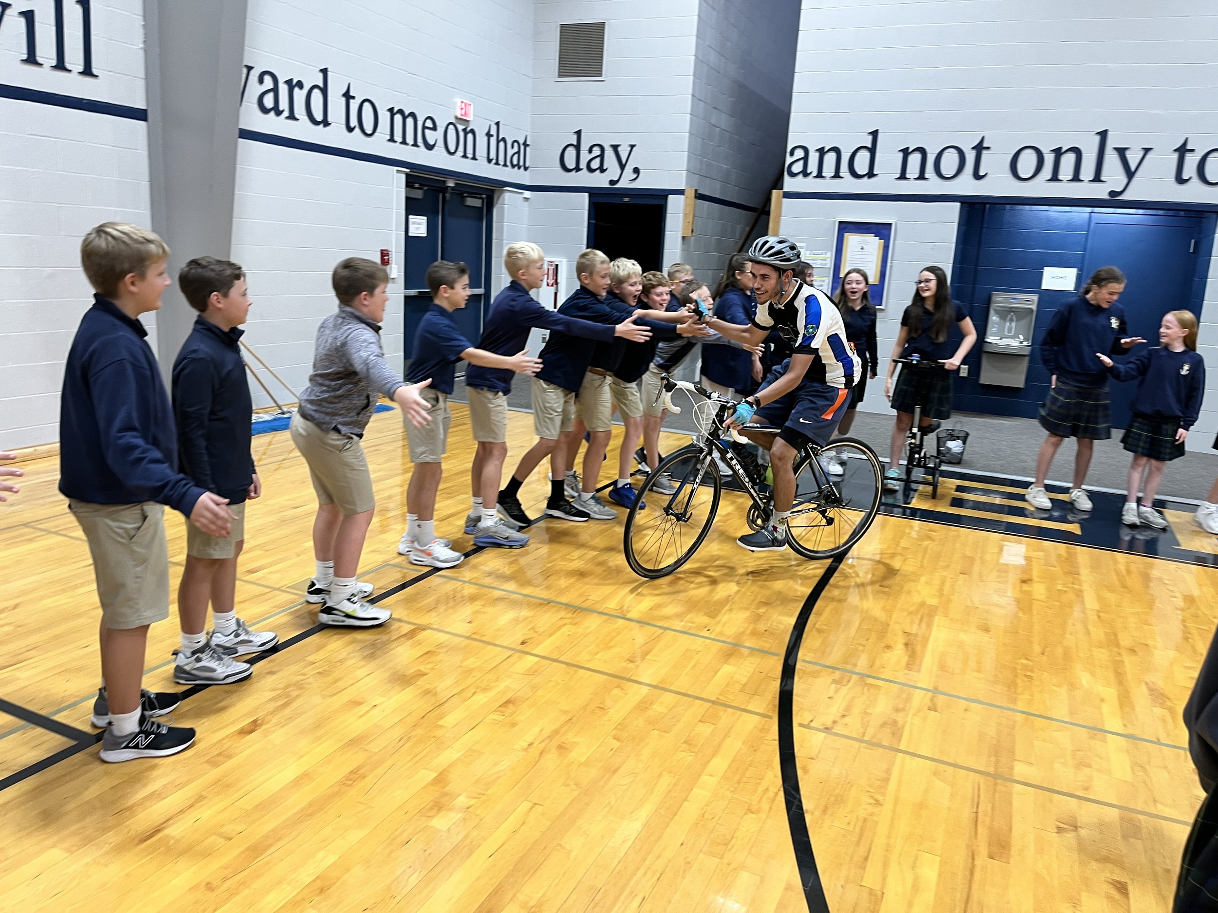 Priests Pedaling for Prayers Visit