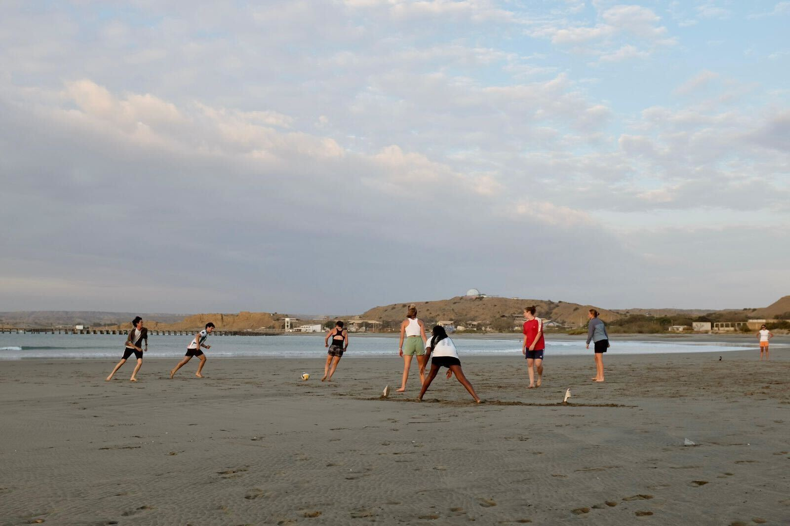 Volunteer interns playing football on the Lobitos beach at sunset!